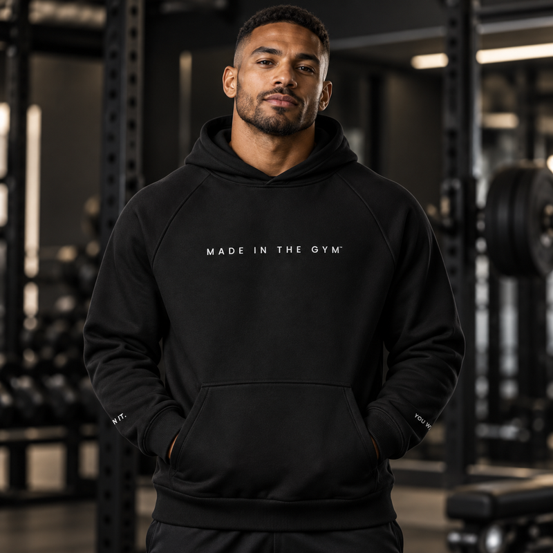 Adult male athlete wearing the black MITG Unseen heavyweight drawstring-free hoodie, front view
